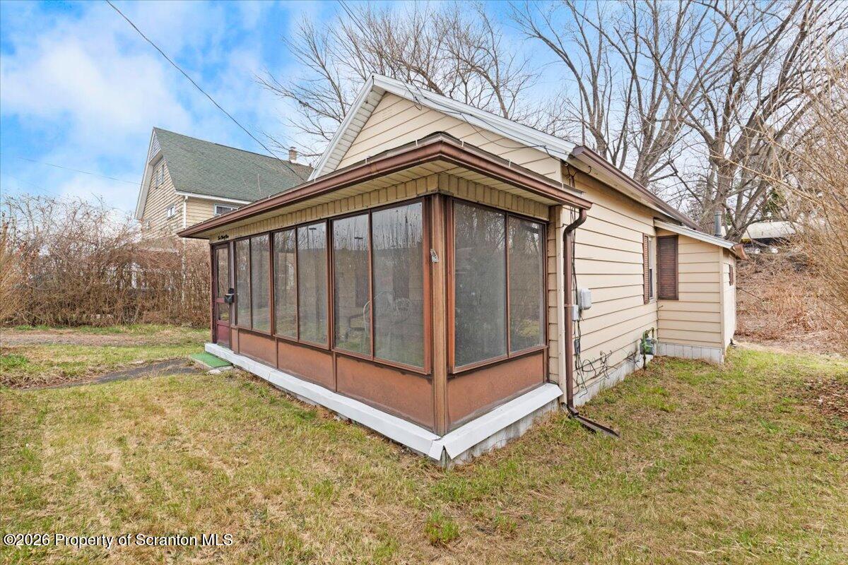 499 Meridian Avenue Scranton, PA 18504 - Photo 3 of 24 a view of a house with a yard and wooden fence