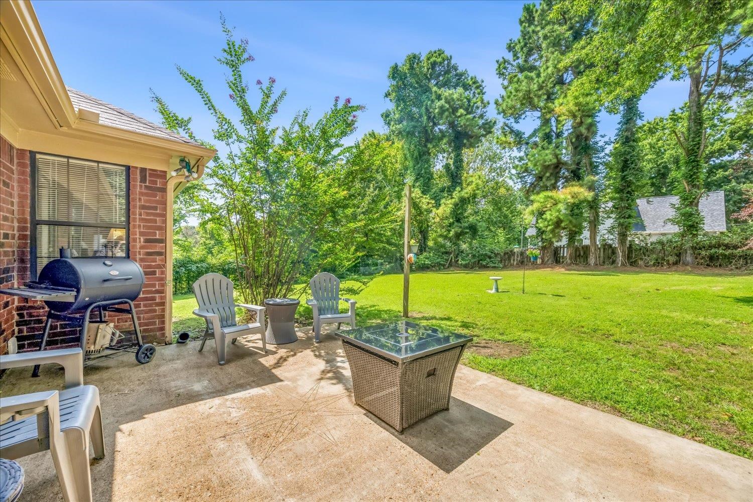184 Cherokee Road Millington, TN 38053 - Photo 16 of 27 Spacious concrete patio featuring a brick exterior and large windows