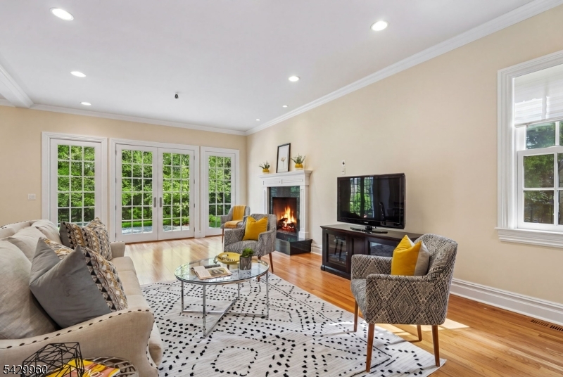 6 Grosvenor Road Short Hills, NJ 07078 - Photo 11 of 50 a living room with furniture a flat screen tv and large windows