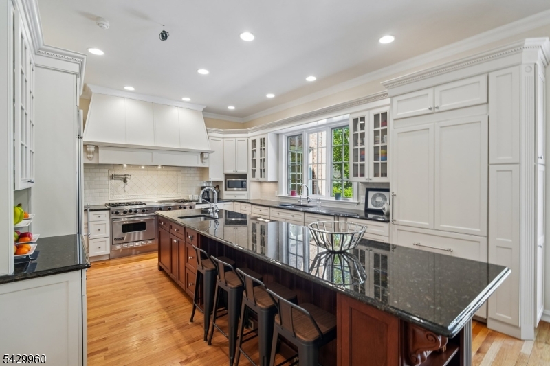 6 Grosvenor Road Short Hills, NJ 07078 - Photo 16 of 50 a kitchen with stainless steel appliances granite countertop a stove a sink dishwasher and a refrigerator with wooden floor