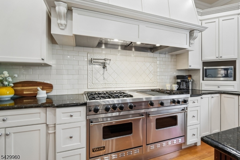 6 Grosvenor Road Short Hills, NJ 07078 - Photo 17 of 50 a white kitchen with granite countertop a stove and a sink