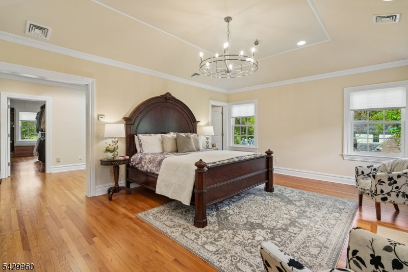 6 Grosvenor Road Short Hills, NJ 07078 - Photo 23 of 50 a bed room with a bed and a chandelier