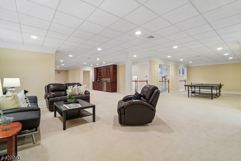 6 Grosvenor Road Short Hills, NJ 07078 - Photo 37 of 50 a living room with furniture and a flat screen tv