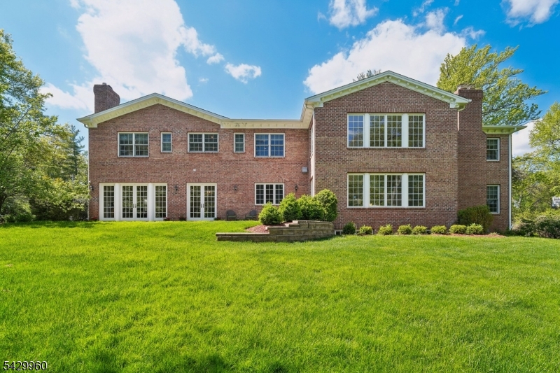 6 Grosvenor Road Short Hills, NJ 07078 - Photo 44 of 50 a front view of a house with a yard
