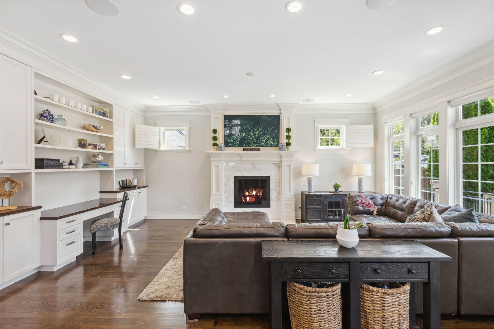 923 Harvard Lane Wilmette, IL 60091 - Photo 15 of 42 a living room with furniture a flat screen tv and a fireplace