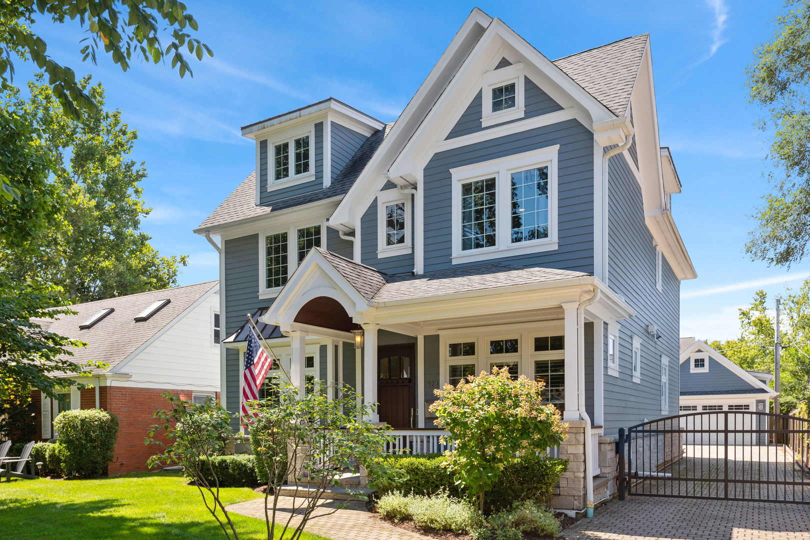 923 Harvard Lane Wilmette, IL 60091 - Photo 2 of 42 a front view of a house with a yard and potted plants
