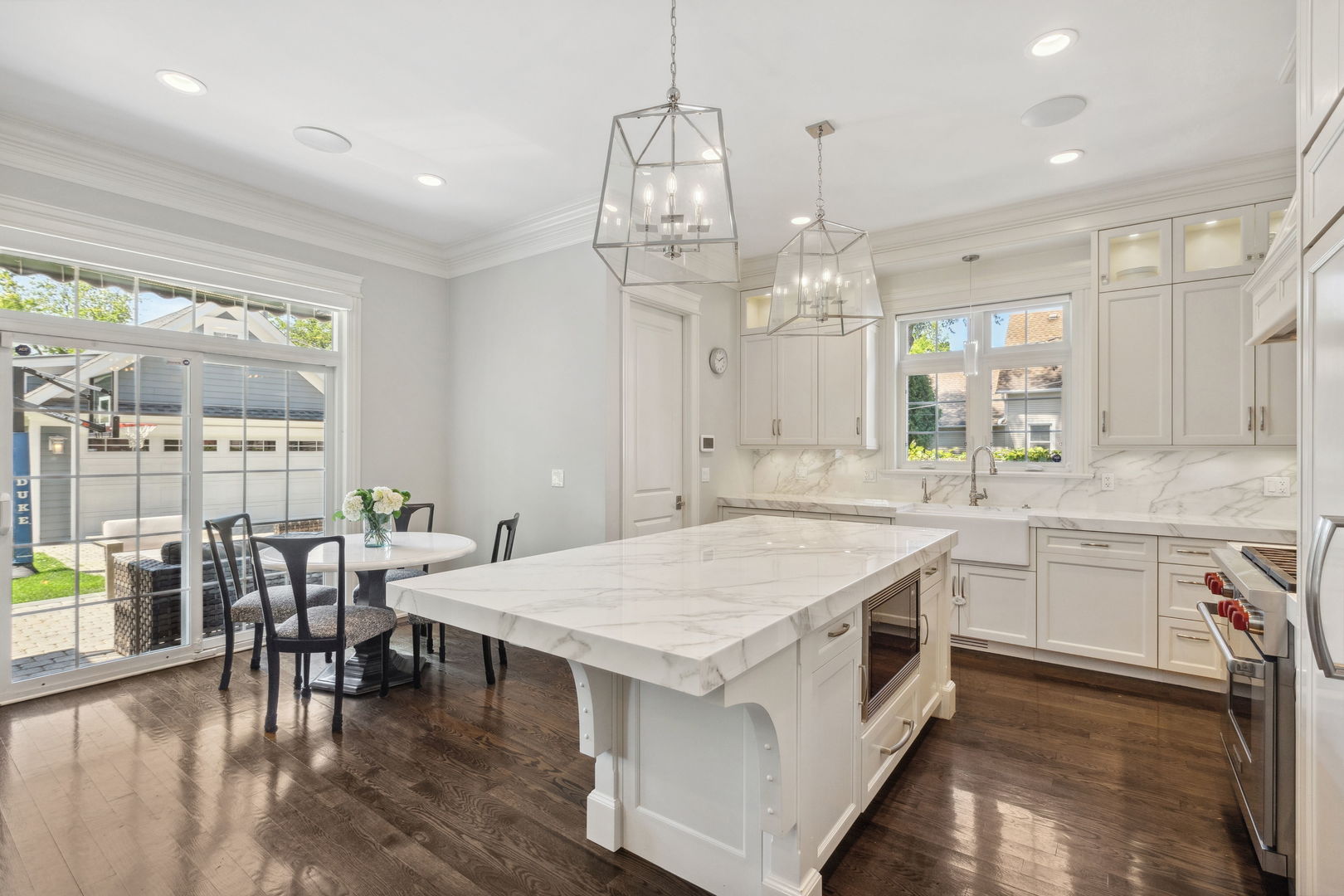 923 Harvard Lane Wilmette, IL 60091 - Photo 9 of 42 a kitchen with center island table and chairs in it