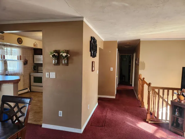 a view of a hallway with wooden floor and entryway