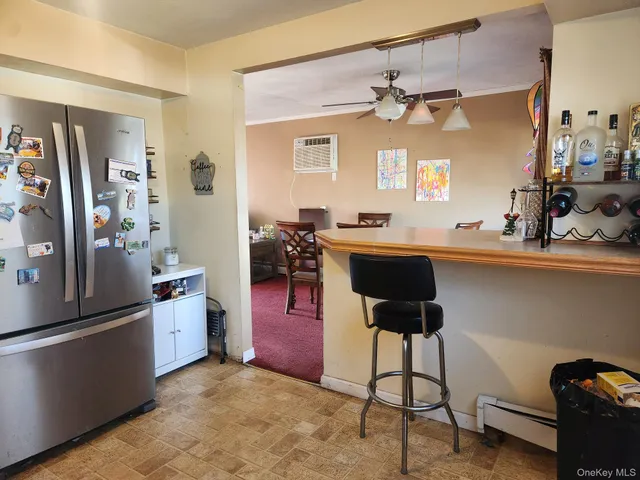 a kitchen with stainless steel appliances a dining table chairs and granite counter tops