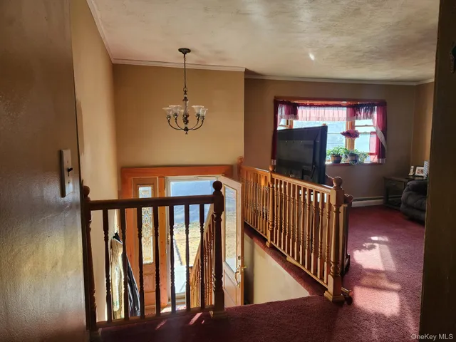 a view of a livingroom with wooden floor and furniture