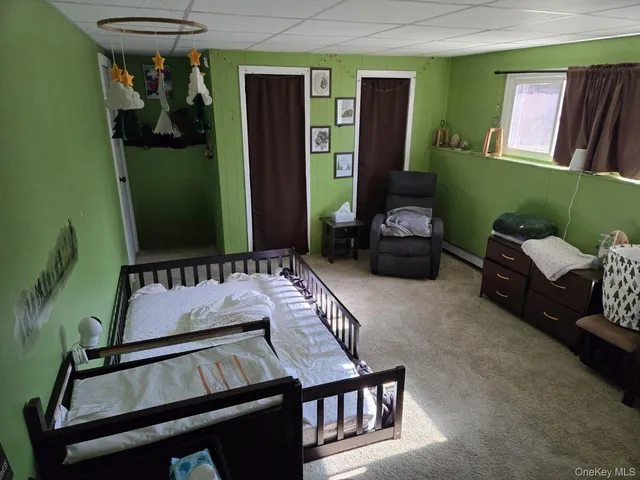 a living room with furniture and a mirror