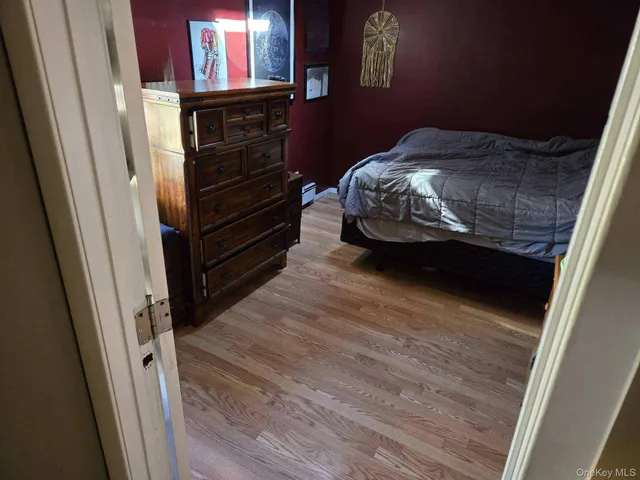 a bedroom with a bed and a dresser