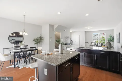 a kitchen with granite countertop a sink and stove