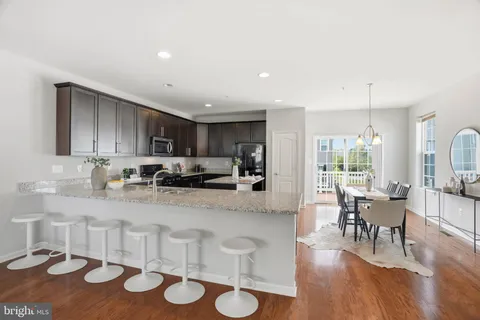 a large kitchen with lots of counter space and breakfast area