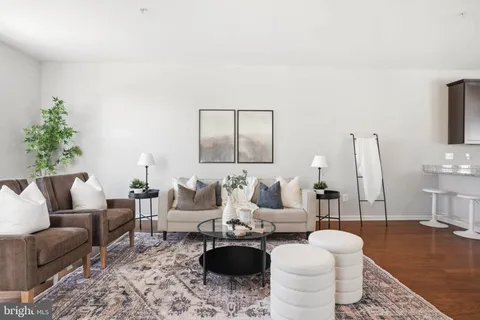 a living room with furniture a rug and a fireplace