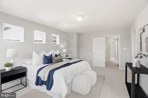 a bedroom with a bed and a couch