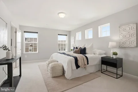 a spacious bedroom with a bed and a table