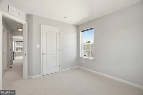 an empty room with windows and closet
