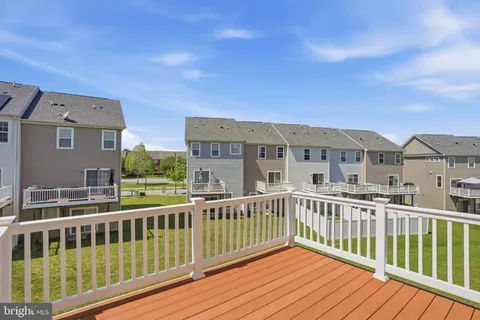 a view of a large building with a wooden deck