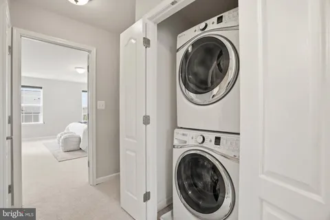 a view of a hallway with washer and dryer