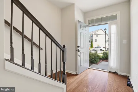 a view of an entryway with wooden floor and windows