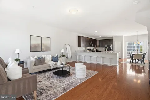 a living room with furniture and view of kitchen