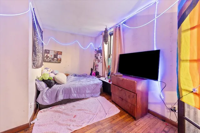 a bedroom with a bed and a flat screen tv