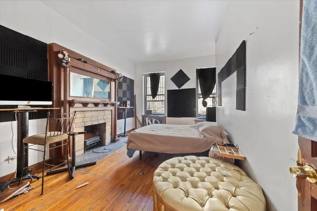 a bedroom with a bed and a fireplace