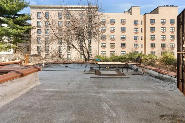 a view of a backyard with furniture and a fire pit