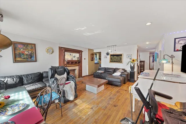 a living room with furniture or wooden floor and a flat screen tv