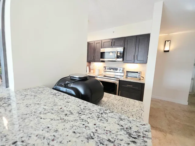 a living room with furniture a rug and a large window