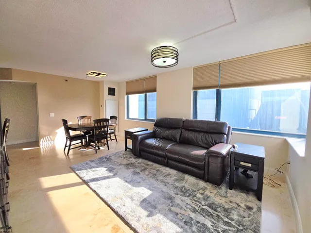 a living room with furniture a window and a table