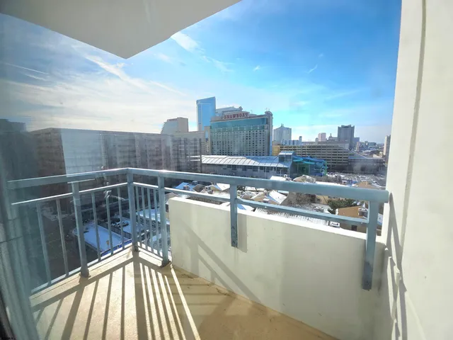 a bedroom with a bed and a flat tv screen on a dresser