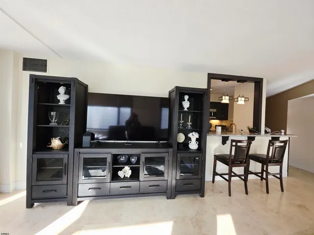 a large bed sitting in a bedroom next to a window