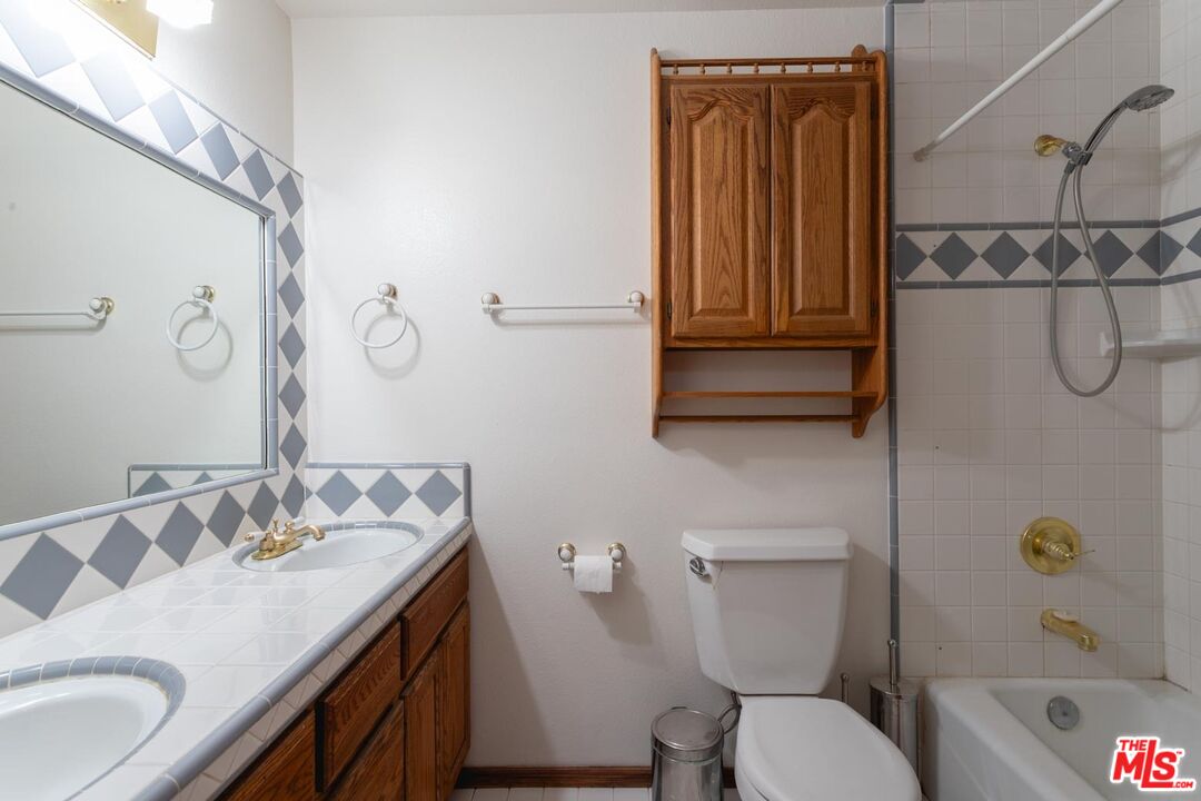 29243 Piani Road Pearblossom, CA 93553 - Photo 23 of 64 a bathroom with a granite countertop toilet sink and mirror