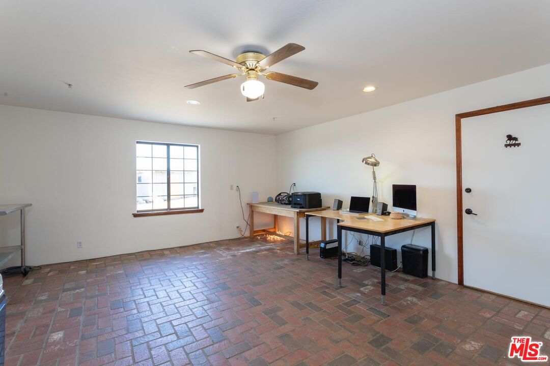 29243 Piani Road Pearblossom, CA 93553 - Photo 25 of 64 a view of a workspace with furniture and a window