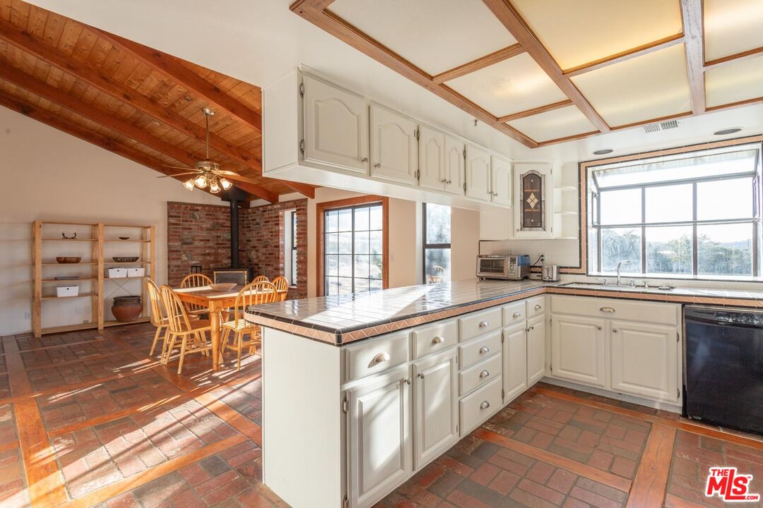 29243 Piani Road Pearblossom, CA 93553 - Photo 10 of 64 a kitchen with stainless steel appliances granite countertop a stove and cabinets