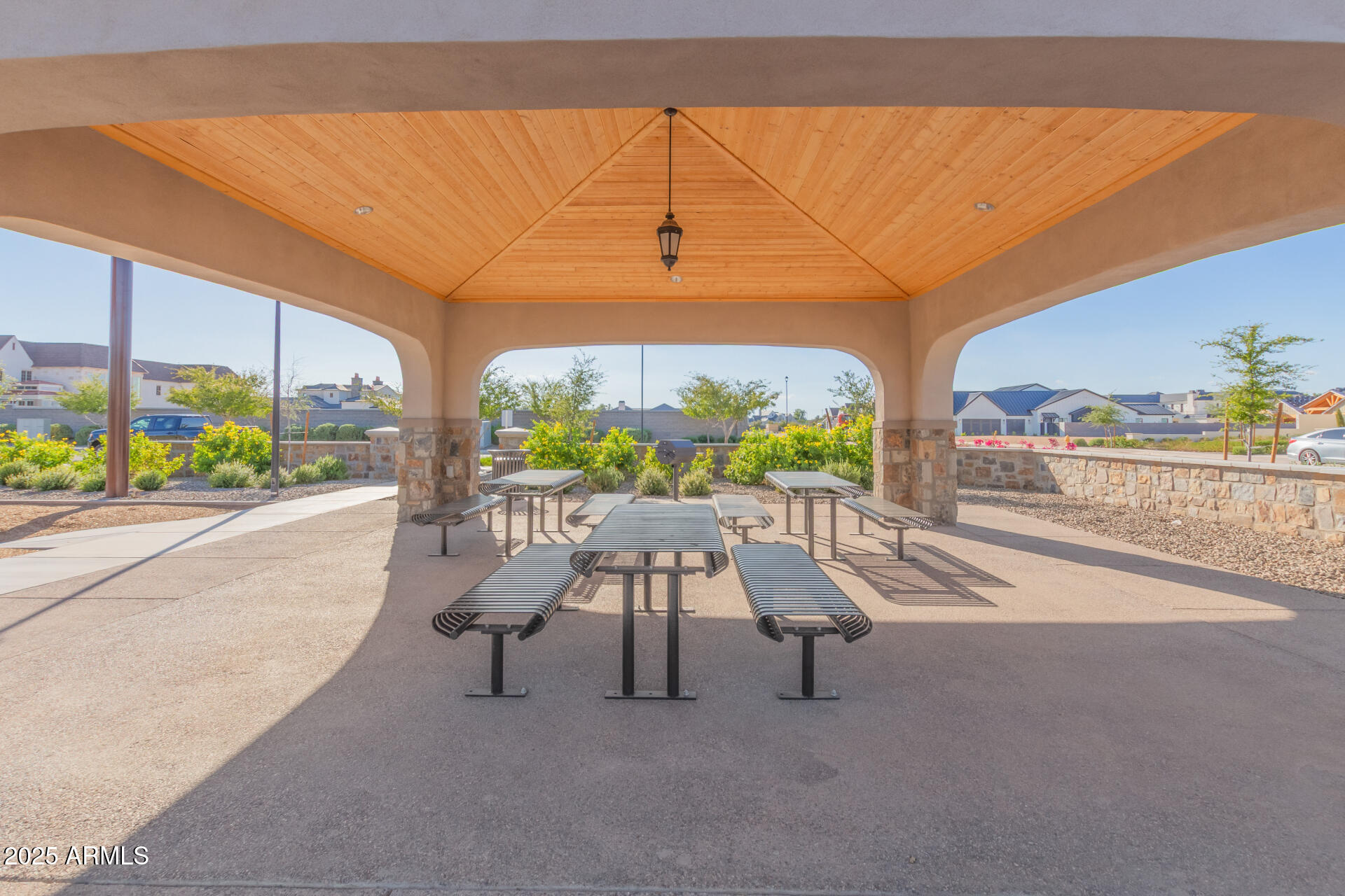 2714 East Blue Sage Road, Unit 128 Gilbert, AZ 85297 - Photo 17 of 18 a view of a patio with a table and chairs and potted plants
