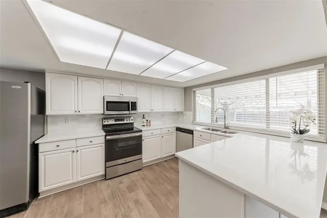 a kitchen with a stove a sink and a refrigerator