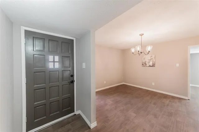 an empty room with closet and windows