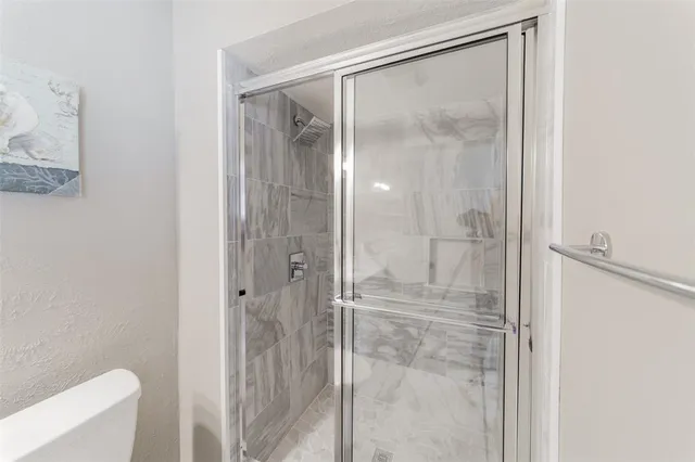 a bathroom with a glass shower door