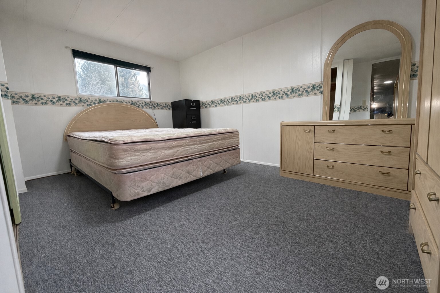 10831 Southeast 226th Street Kent, WA 98031 - Photo 12 of 17 a spacious bedroom with a bed and window
