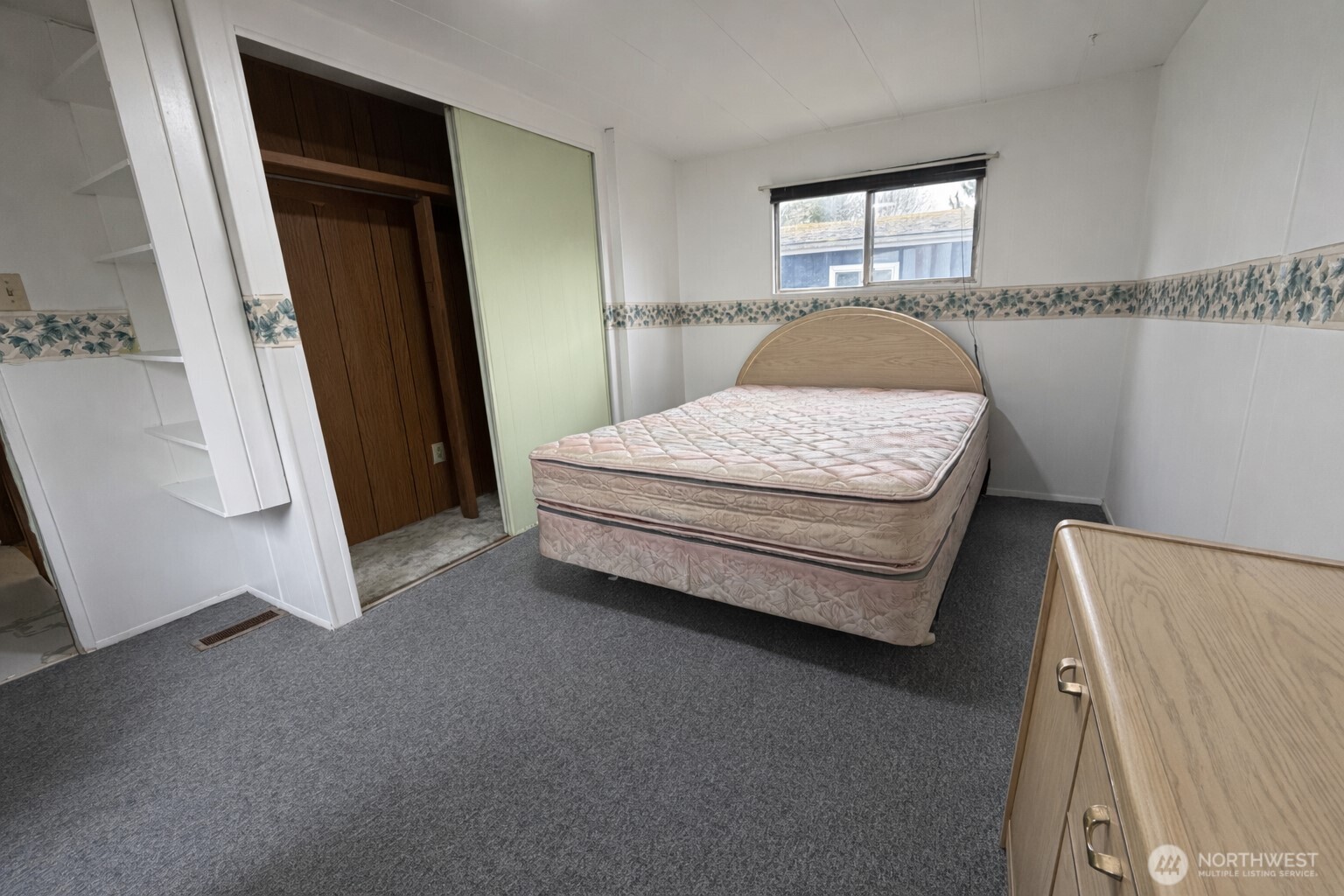 10831 Southeast 226th Street Kent, WA 98031 - Photo 14 of 17 a spacious bedroom with a bed and a window