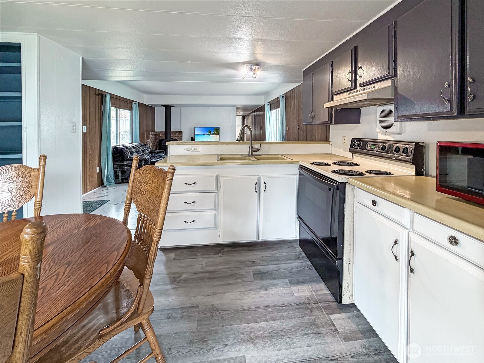 10831 Southeast 226th Street Kent, WA 98031 - Photo 6 of 17 a kitchen with cabinets and chairs