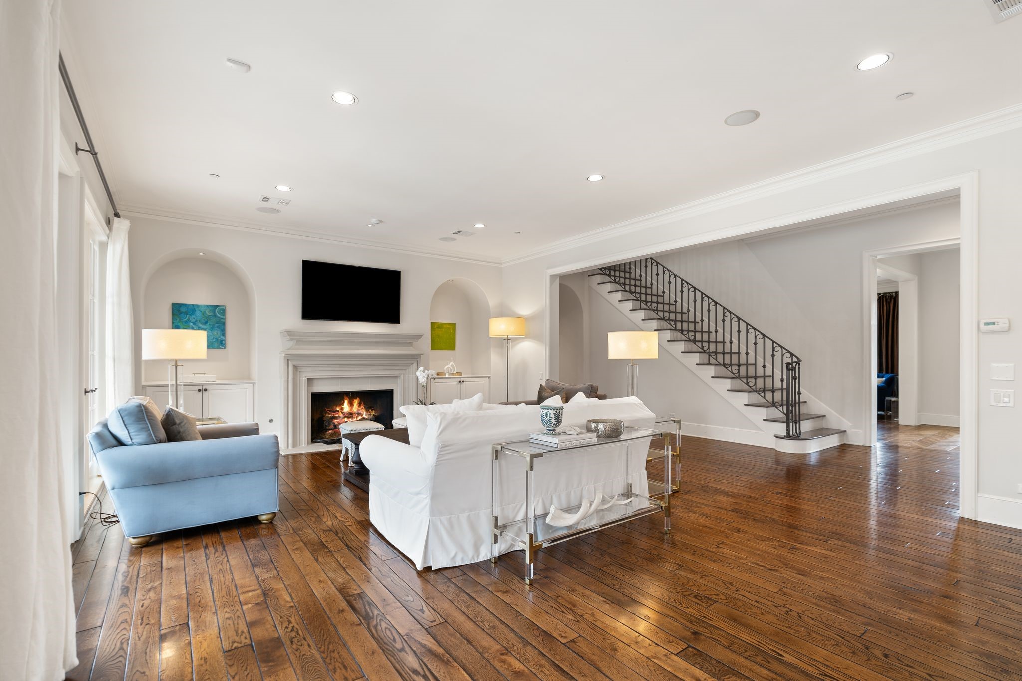 11402 Taylorcrest Road Houston, TX 77024 - Photo 19 of 44 View from the family room back toward the entry highlights the home’s thoughtful layout & architectural detailing. The staircase, cased openings & crown molding create a refined backdrop.