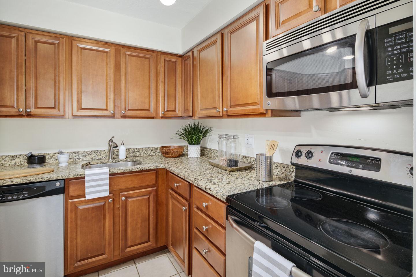 1420 Locust Street, Unit 11D Philadelphia, PA 19102 - Photo 3 of 20 a kitchen with stainless steel appliances granite countertop a sink stove and microwave
