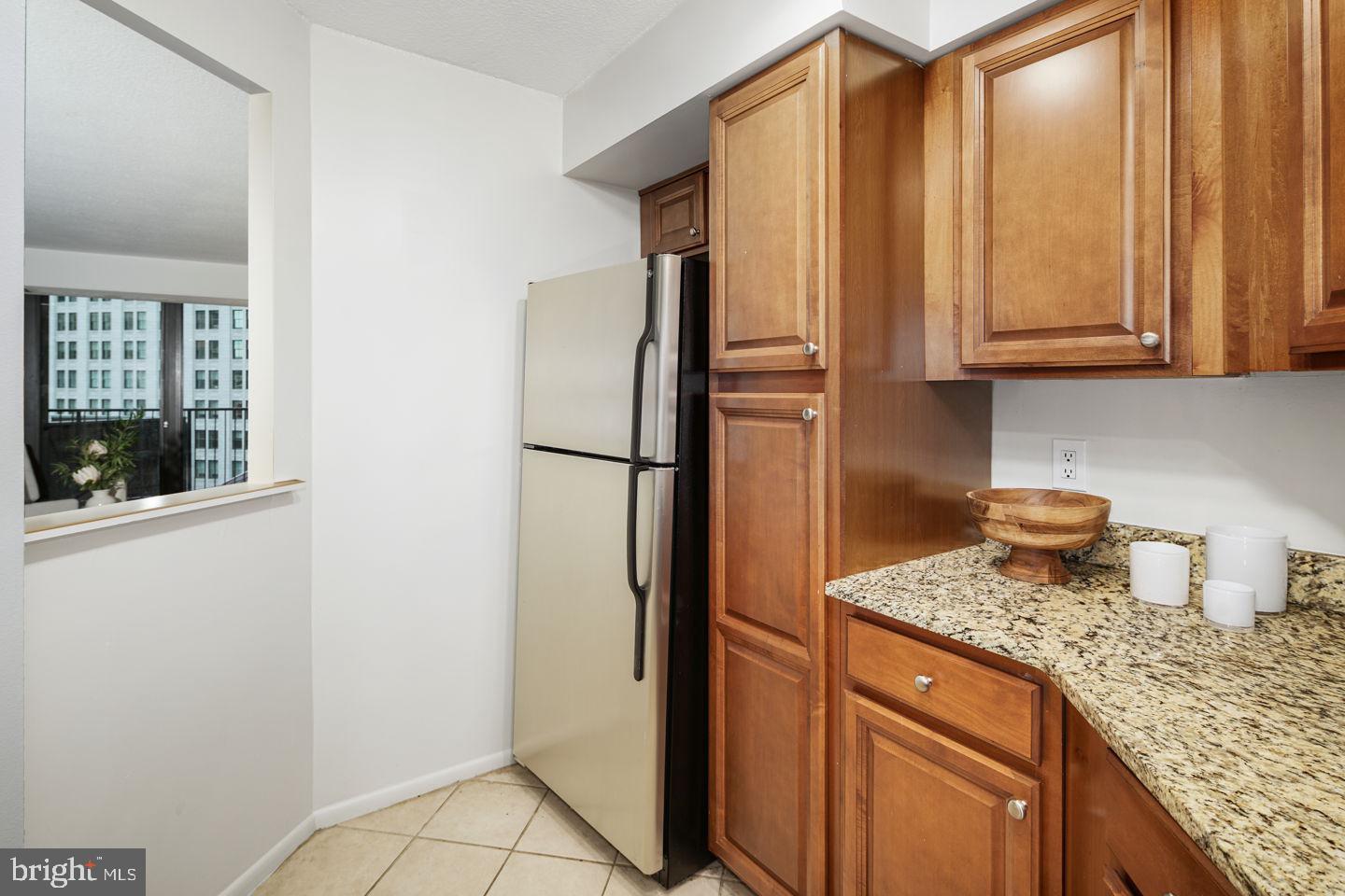 1420 Locust Street, Unit 11D Philadelphia, PA 19102 - Photo 4 of 20 a kitchen with granite countertop a refrigerator and a sink