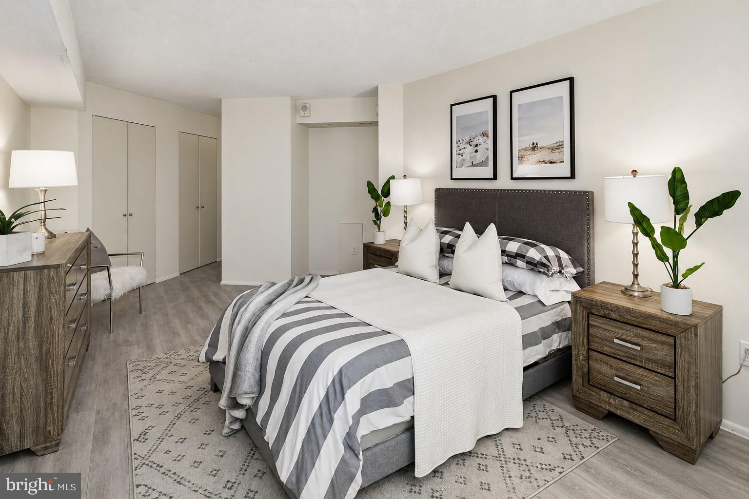 1420 Locust Street, Unit 11D Philadelphia, PA 19102 - Photo 7 of 20 a bedroom with a bed and dresser with chair