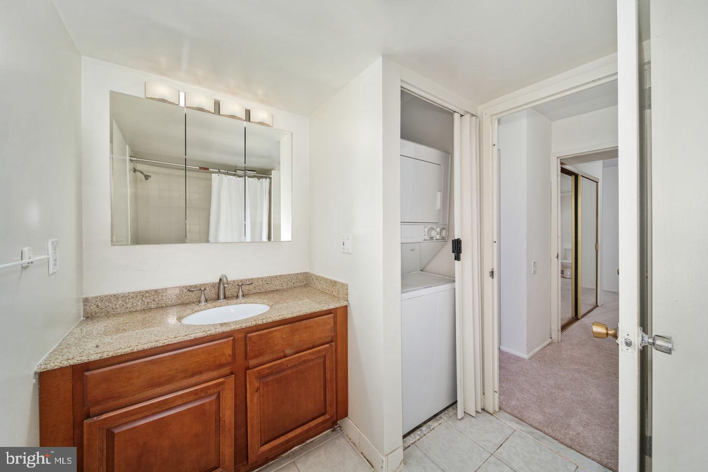 1420 Locust Street, Unit 11D Philadelphia, PA 19102 - Photo 9 of 20 a bathroom with a granite countertop sink and a mirror