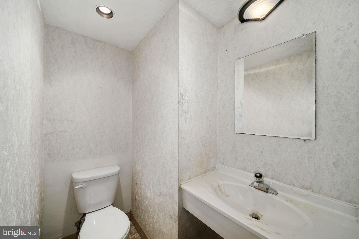 1420 Locust Street, Unit 11D Philadelphia, PA 19102 - Photo 10 of 20 a bathroom with a sink a toilet and mirror